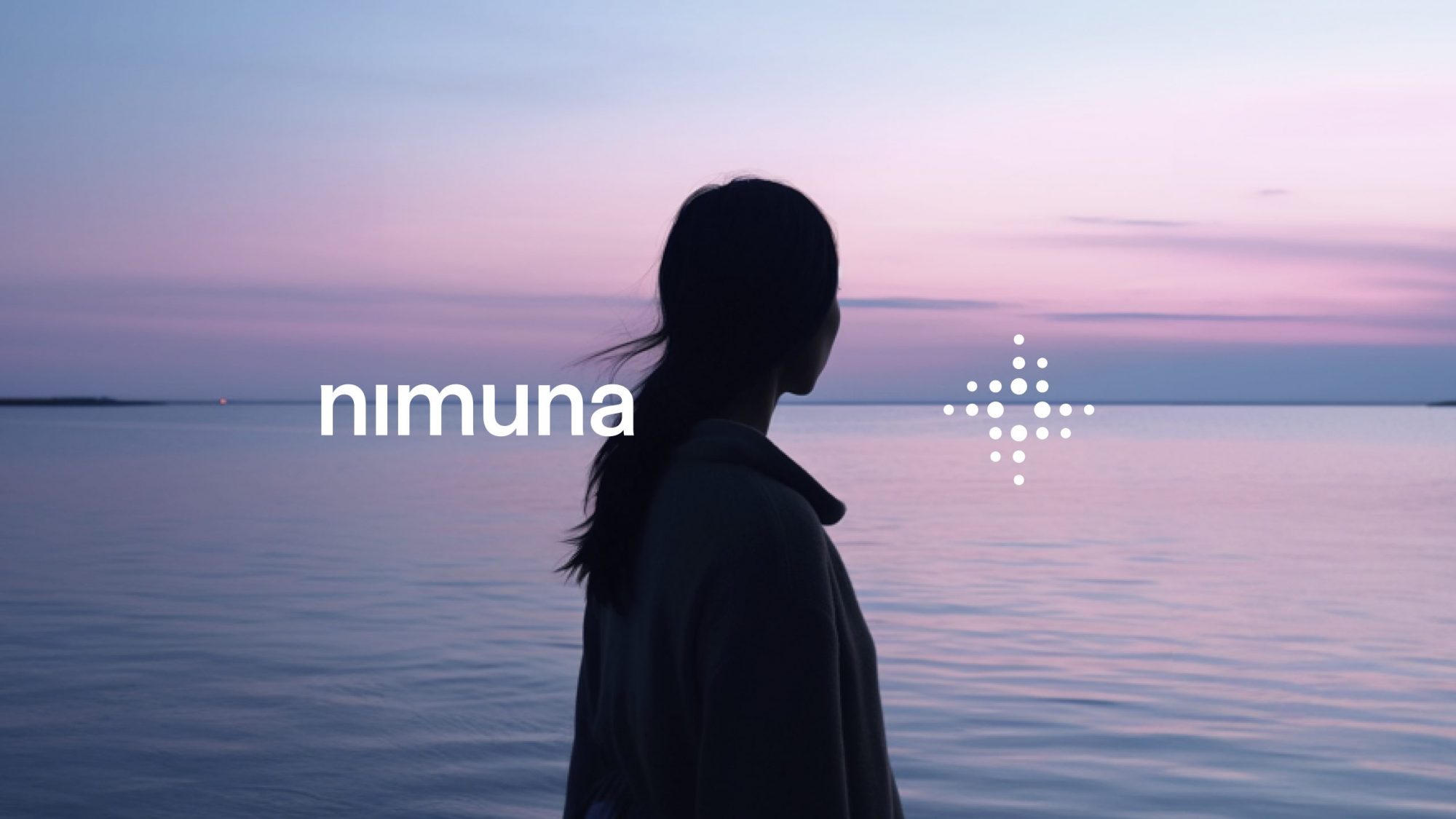 A minimalist logo featuring interconnected dots and stylish typography, complemented by a serene image of a woman gazing out towards the tranquil sea